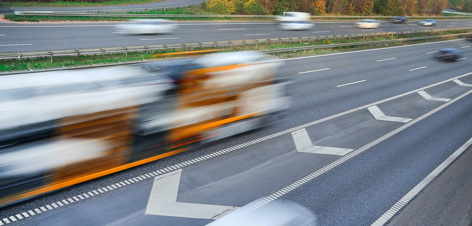 Fast moving vehicles at motion blur on the highway